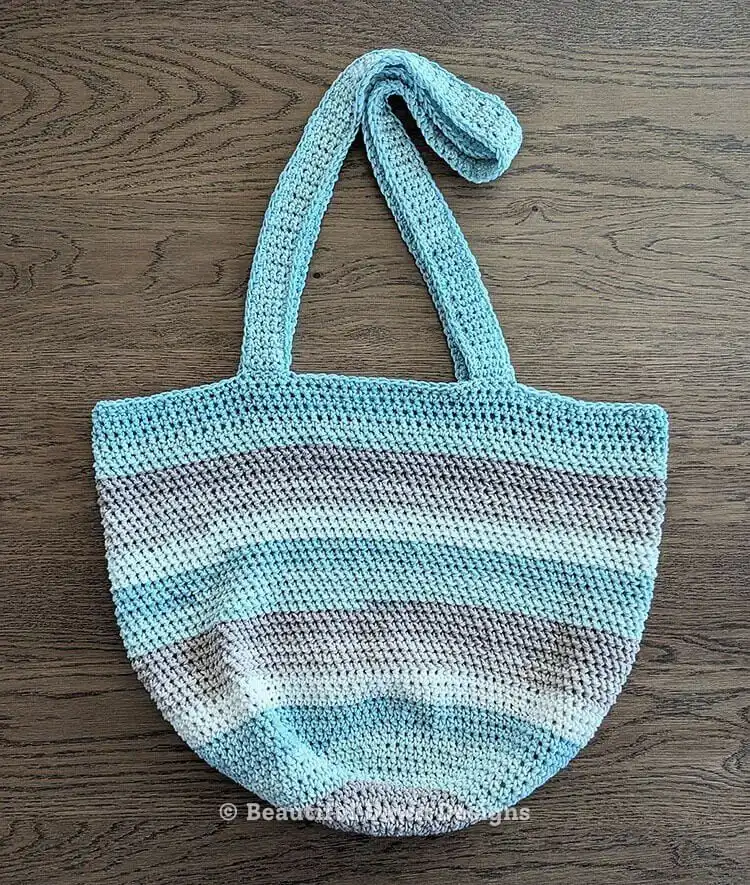 Easy Crochet Flower Bag Pattern 3 Blue and white striped Seaside Tote crochet bag with thick handles, ideal for beach.