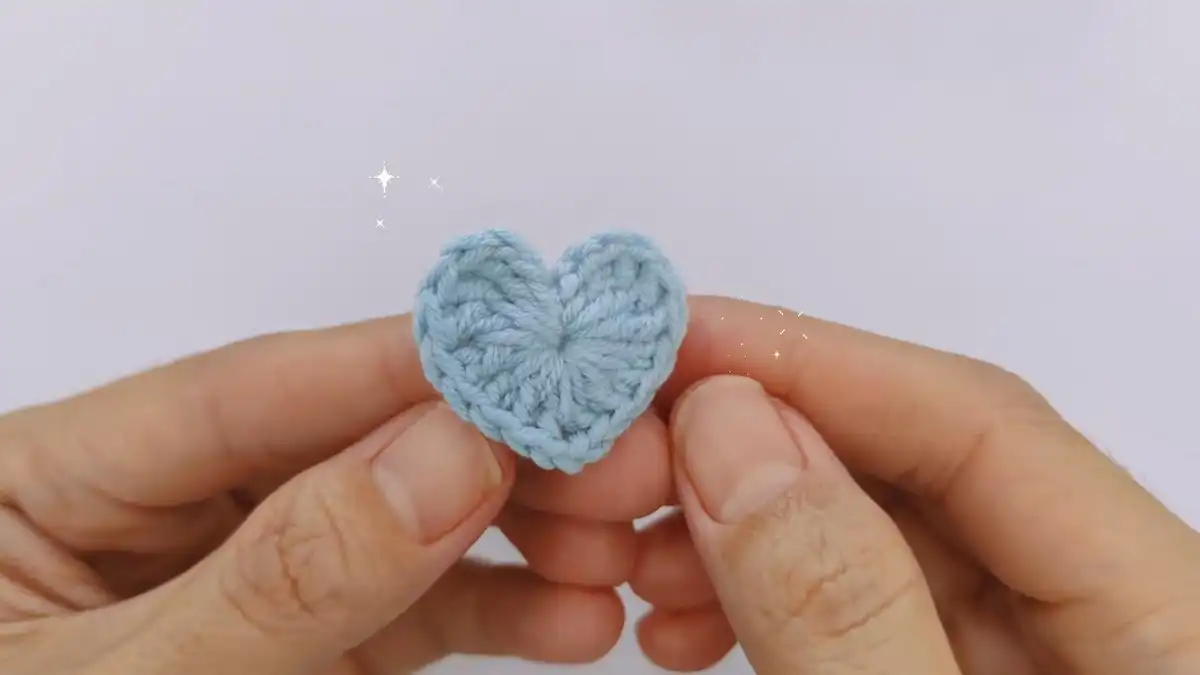 Close-up of the finishing touches for the Easy & Free Crochet Heart Pattern, including slip stitch and weaving ends.