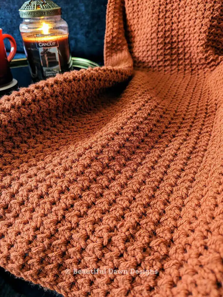 Detailed shot of crochet hooks and yarn, representing the materials for the Easy One Row Repeat Crochet Blanket Free Pattern