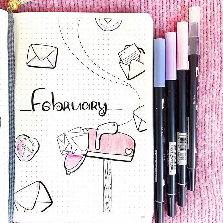 Whimsical bullet journal cover page design showing a mailbox overflowing with letters, some with tiny hearts.