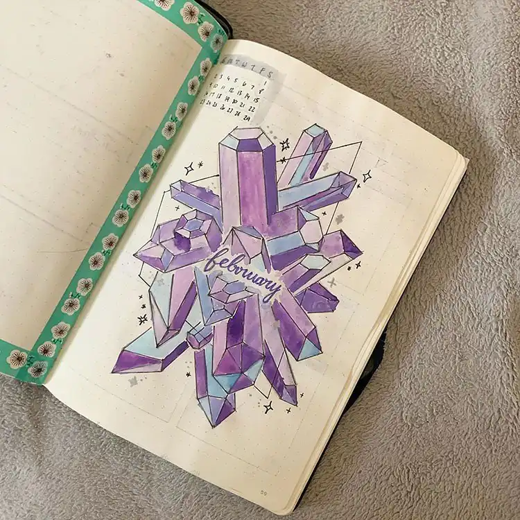 Creative mood tracker in a bullet journal featuring flowers in a jar, each colored to represent a daily mood.