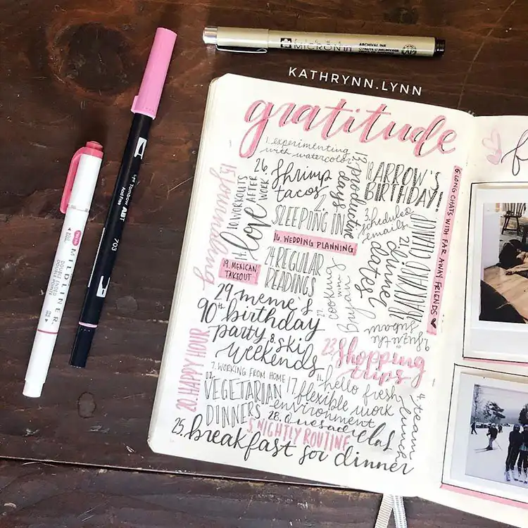 Cute hand-drawn strawberries in pink and red on a simple bullet journal cover page for February.