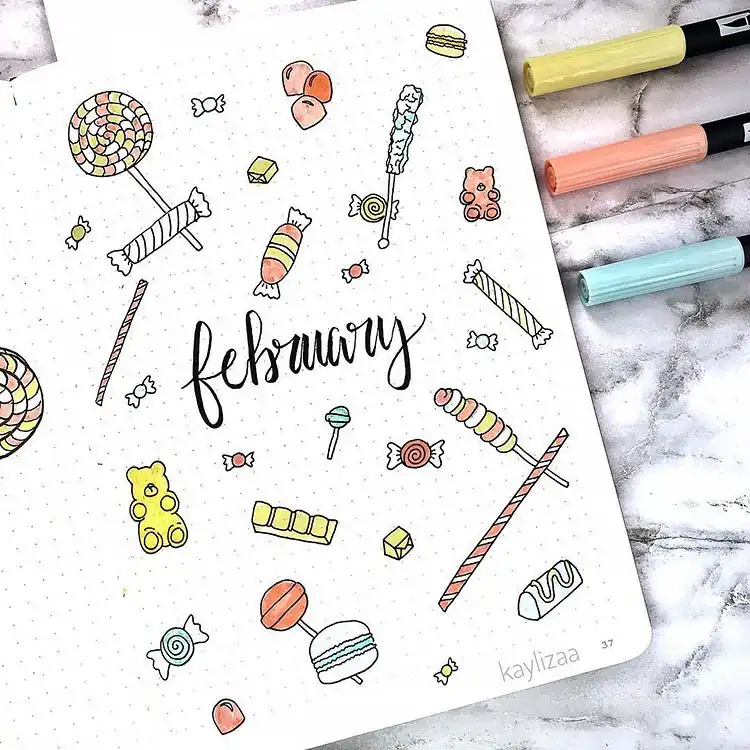 Sweet treats themed bullet journal cover page with various candies, lollipops, and desserts.