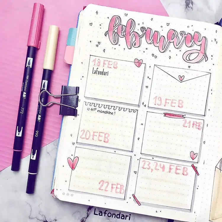 Vibrant bullet journal cover page with pink and purple hearts, some featuring playful Valentine's phrases.