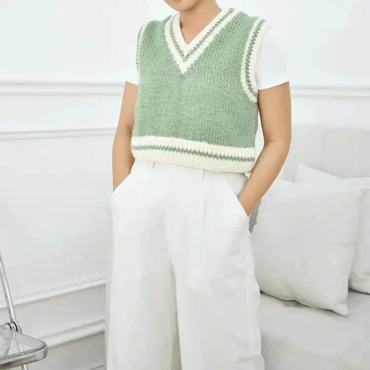 A v-neck Chunky Knitted Vest in a vibrant color, showcasing its thick texture and modern design.