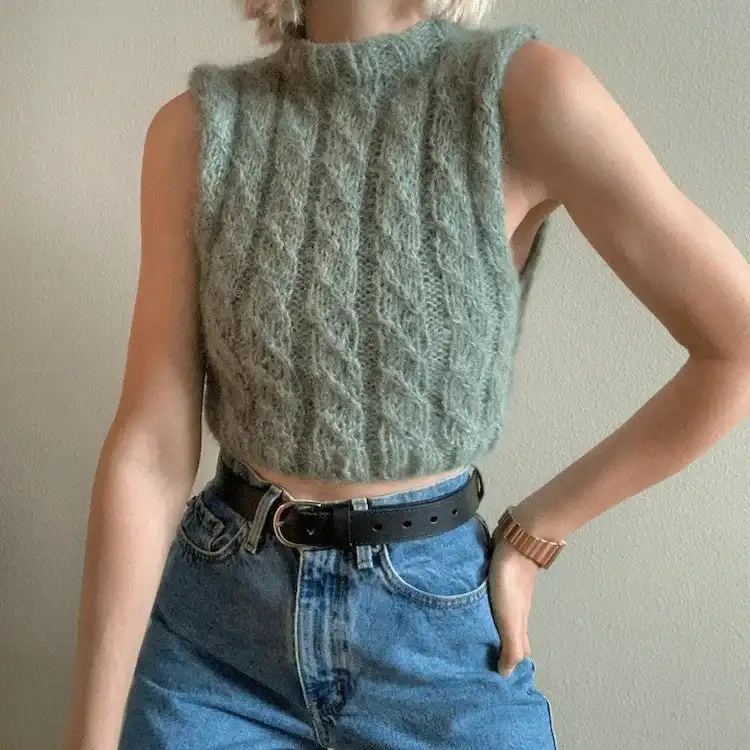 Cropped Basic Cable Vest, highlighting the uniform 1/1 left cross stitch cable pattern on a textured background.