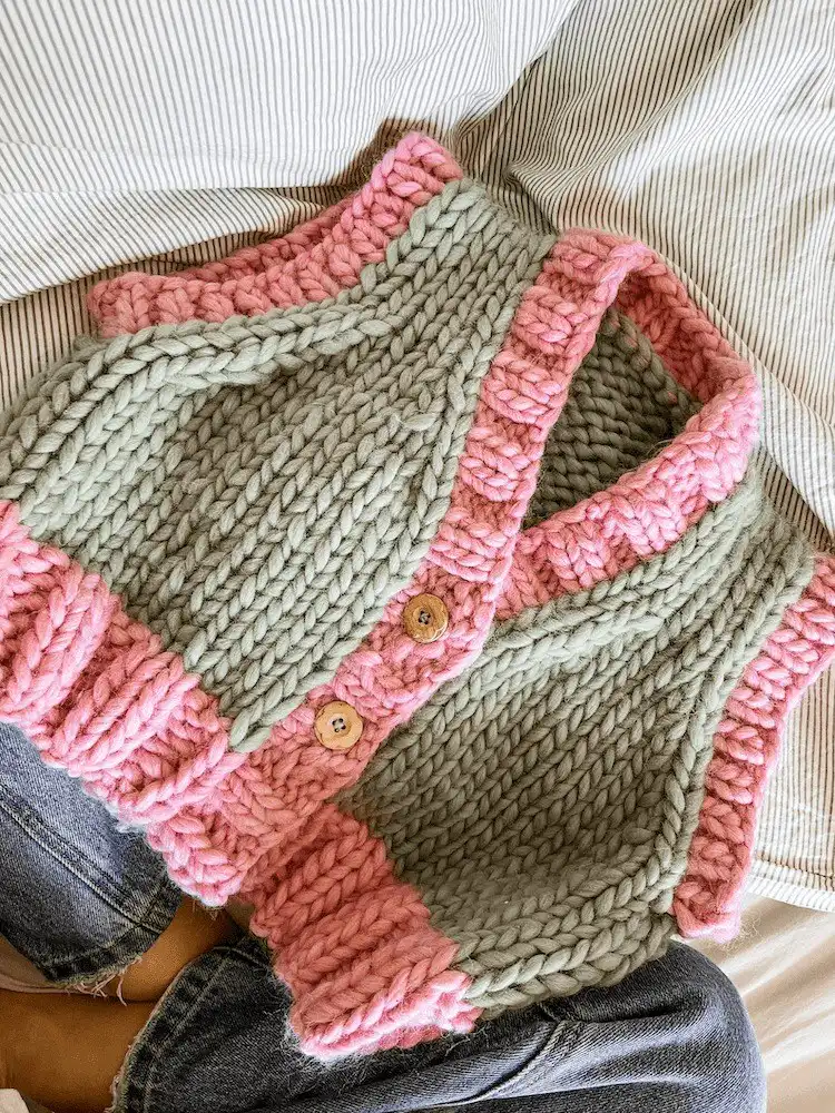 Cropped Mama Knows Vest Cardivest with buttons, knitted in a soft yarn, suitable for using up remnants.