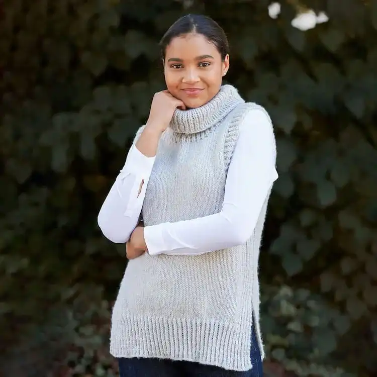 A warm, high-neck Turtleneck Vest in a dark, cozy yarn, ideal for winter layering.