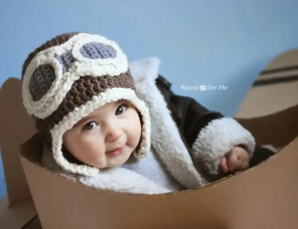 A red and white knitted hat with a white pom-pom, representing the Child Size 30-Minute Beanie from Free Crochet Hat Patterns for Babies and Kids.