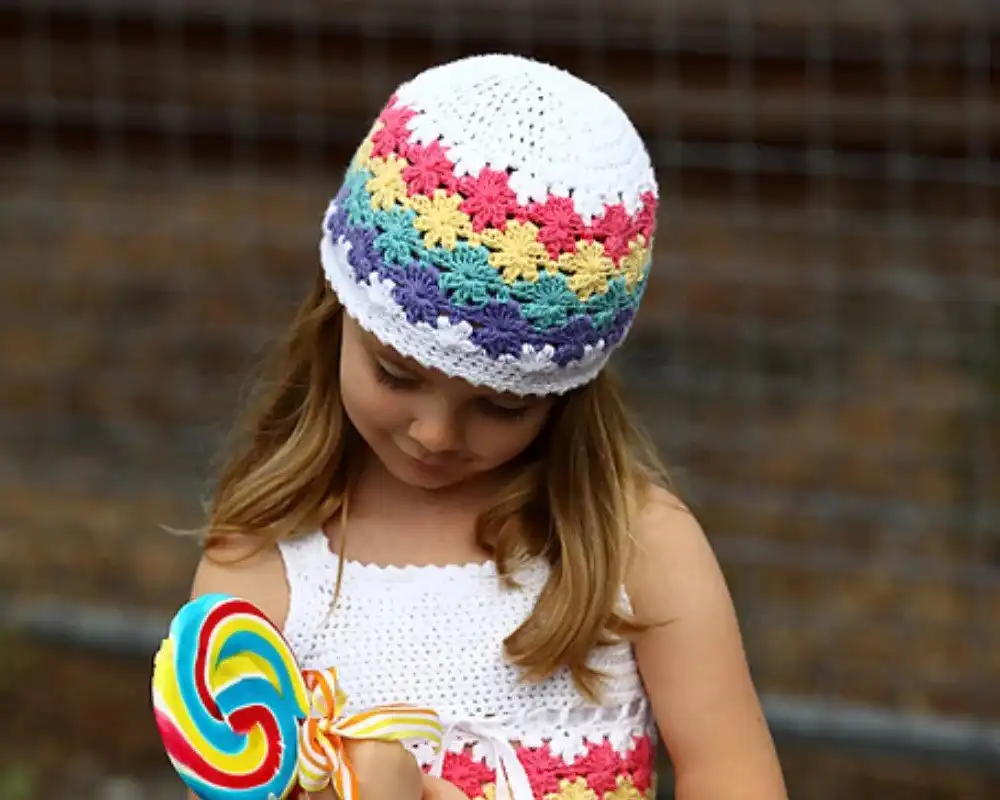 A child wearing a warm crocheted earflap hat in the snow, illustrating the Seamless Earflap Hat from Free Crochet Hat Patterns for Babies and Kids.