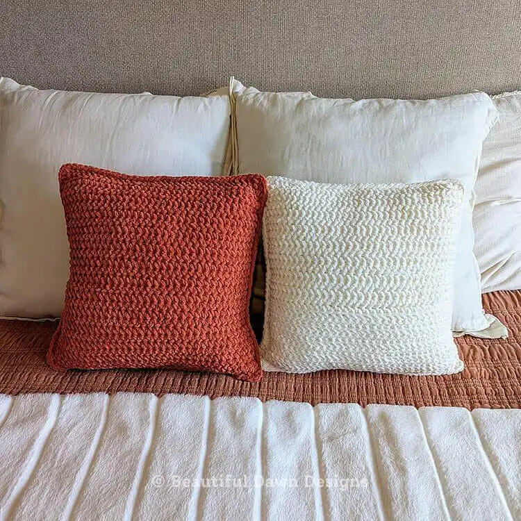 Two finished Free Crochet Pillow Pattern Using Super Bulky Bernat Blanket Yarn cushions displayed together, highlighting their cozy appeal.