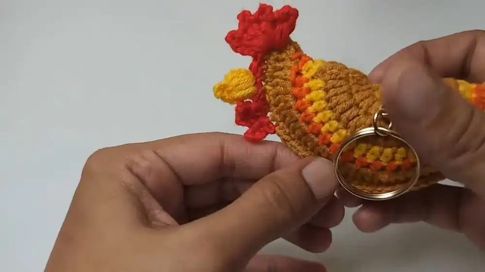 Close-up of the yellow beard being crocheted for the Free Crochet Rooster Keychain Pattern, showing textured stitches.