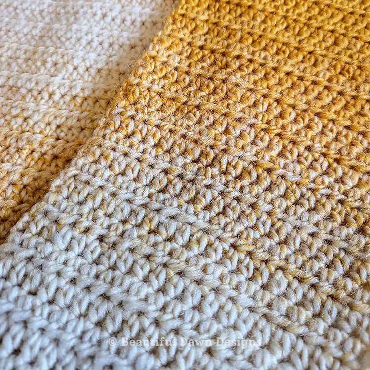 A stylishly draped finished crochet scarf, showcasing its length and color transitions, made from the Free Crochet Scarf Pattern for Absolute Beginners.