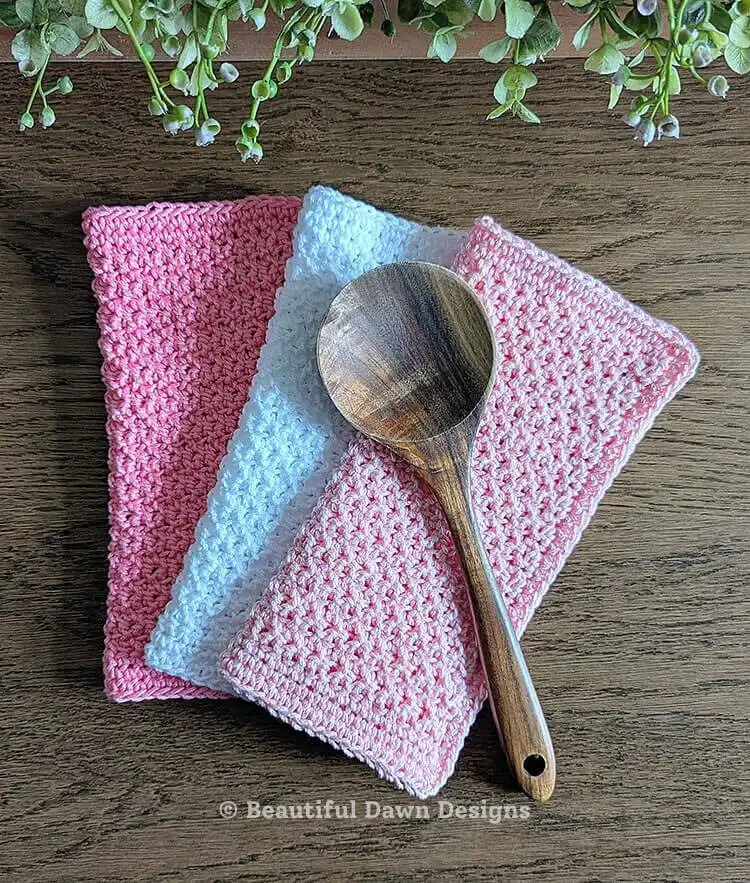 A green Beginner Friendly Crochet Dishcloth laid flat, demonstrating simple stitch work.