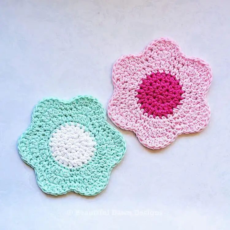 Three Easy Flower Coasters in varying pastel colors, arranged on a surface.
