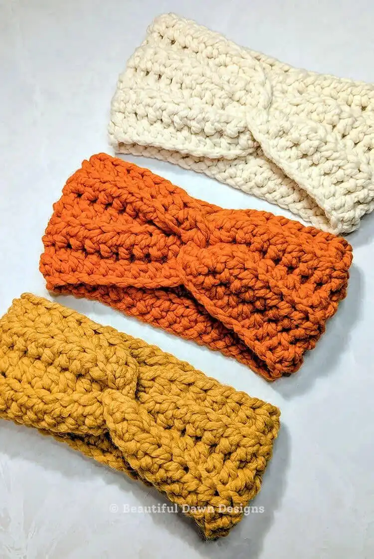 A model wearing a chunky 20 Minute Chunky Crochet Ear Warmer in a cream color, styled for warmth.