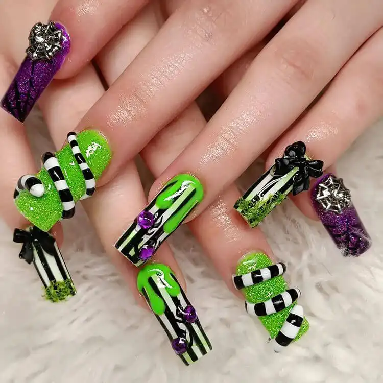 Chic square Glow in the Dark Beetlejuice Nails with crisp black and white vertical stripes.