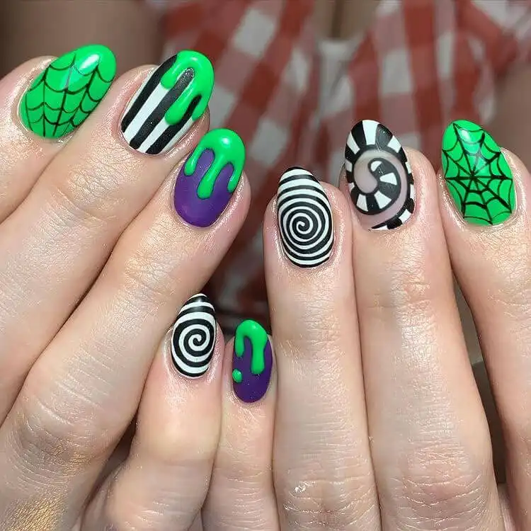 Beautiful Glow in the Dark Beetlejuice design on natural nails, showing detailed art without extensions.