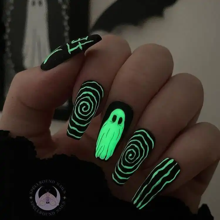 Captivating Glow in the Dark Beetlejuice Nails with stripes and accents that illuminate in the dark.