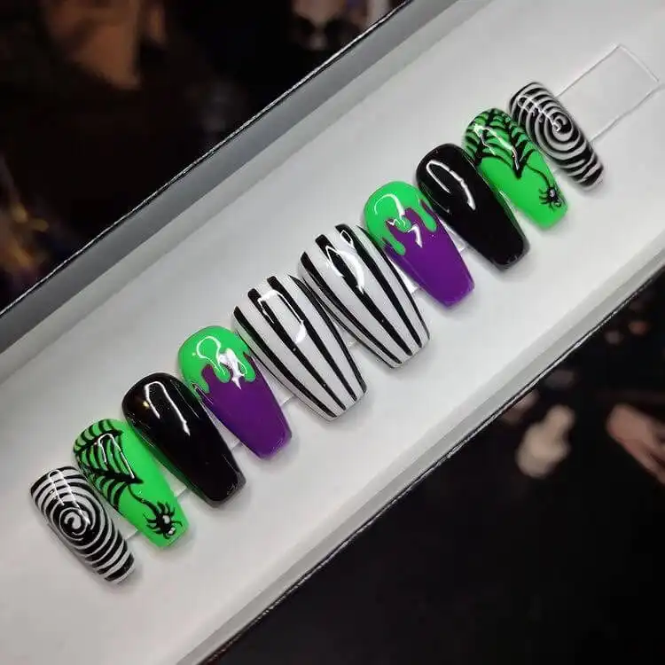 Elegant purple, white, and black press-on Glow in the Dark Beetlejuice Nails with sophisticated patterns.