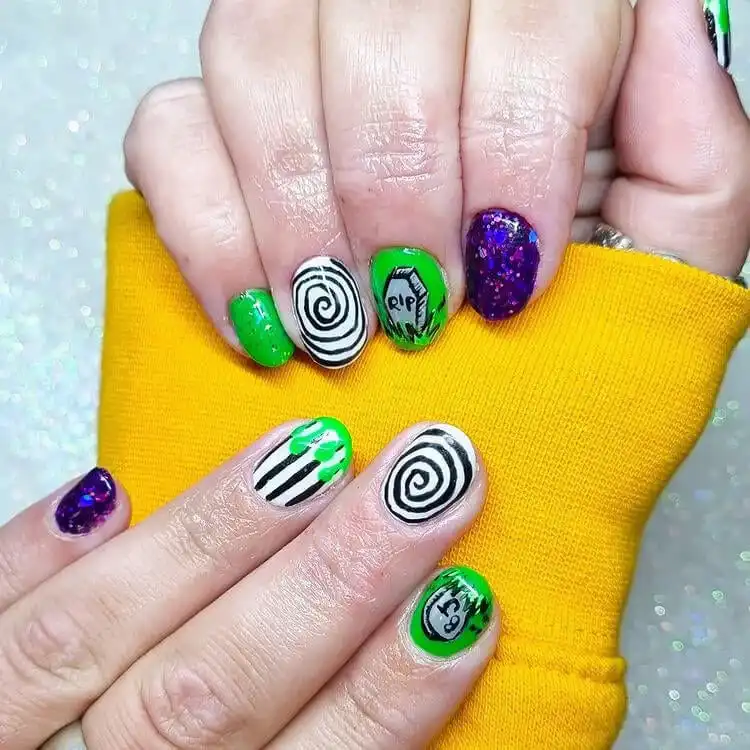 Spooky gravestone Glow in the Dark Beetlejuice Nails combined with classic stripes and thematic elements.