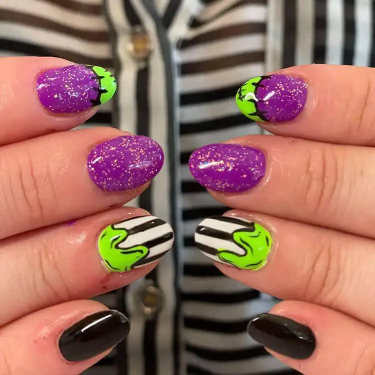 Stylish short Glow in the Dark Beetlejuice Nails with bold green and purple accents and character silhouettes.
