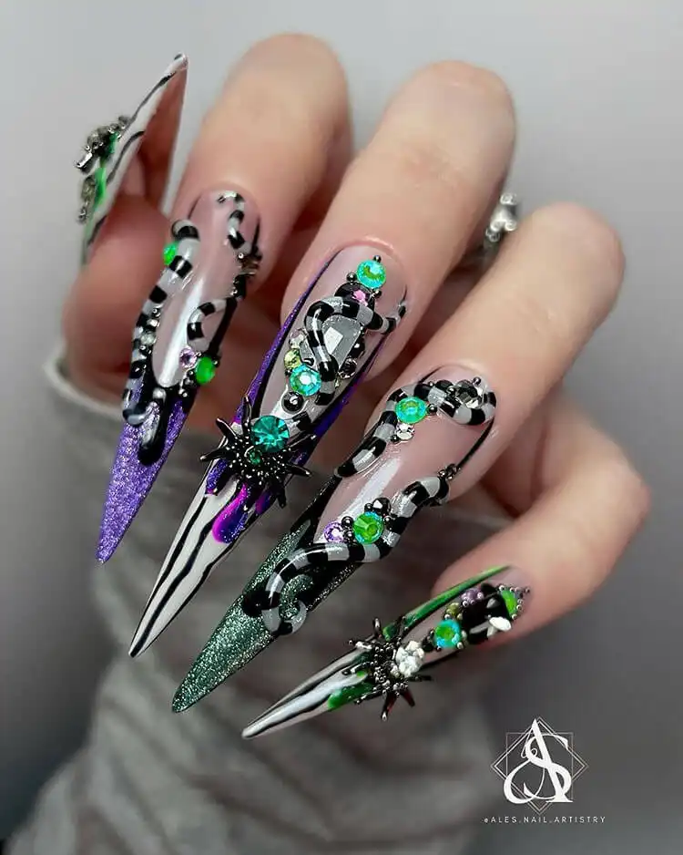Dramatic extra-long stiletto Glow in the Dark Beetlejuice Nails showcasing intricate character portraits and themed art.