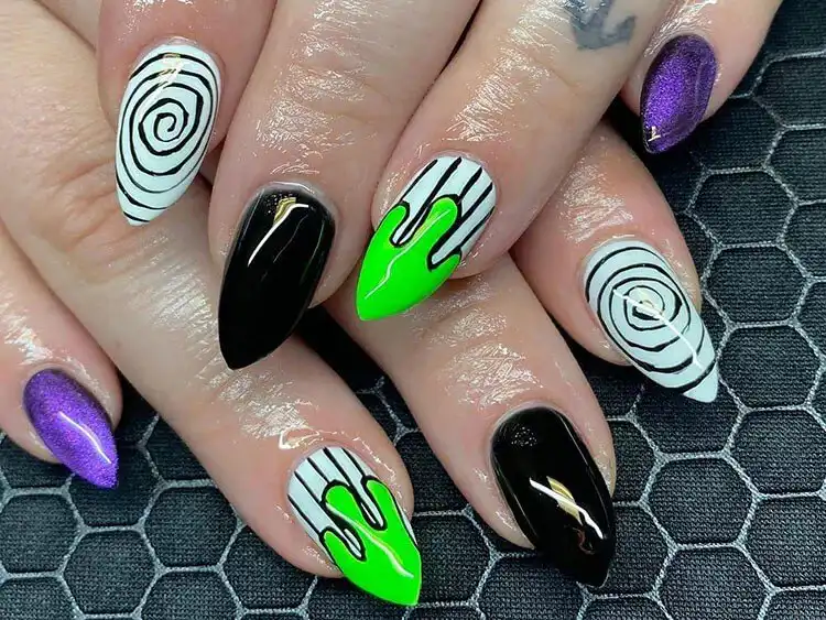 Edgy short stiletto Glow in the Dark Beetlejuice Nails with a mix of spooky colors and character elements.