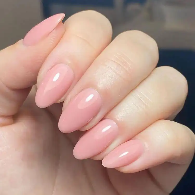 Soft pink almond acrylic nails with a minimalist design, showcasing elegance for women – great for fall, summer, and holidays