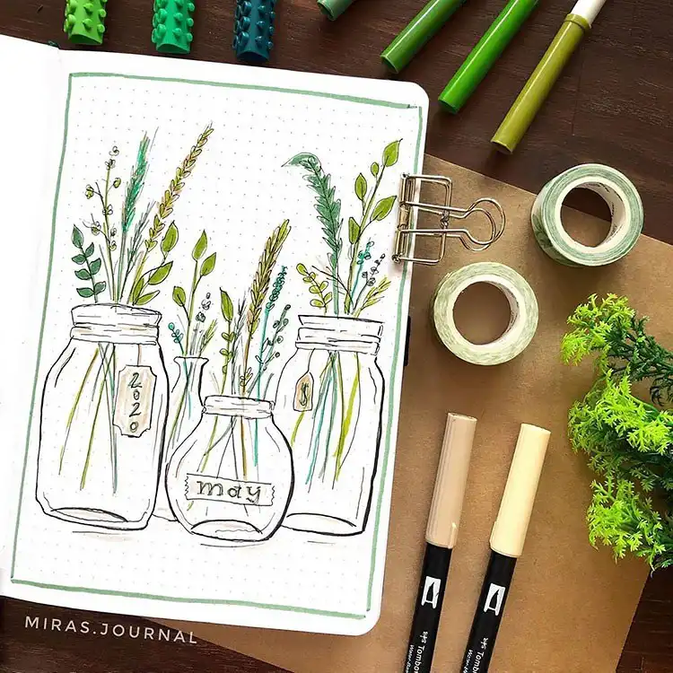 March calendar bullet journal spread decorated with small, intricate succulent drawings around the dates.
