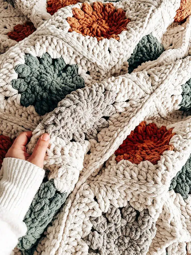 Intricate Winter Blossom Blanket made from delicate granny squares, easy for beginners