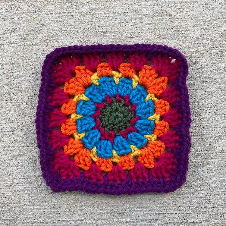 Rainbow-colored Square G-1, a six-inch granny square perfect for using yarn scraps
