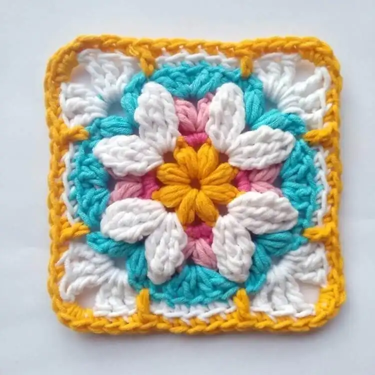 Colorful V-Square crochet granny square, showcasing distinct V-shaped clusters in rainbow hues