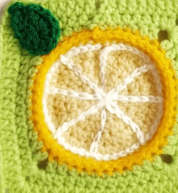 Cute Lemon Granny Square motif with yellow and green yarn, perfect for kitchen decor