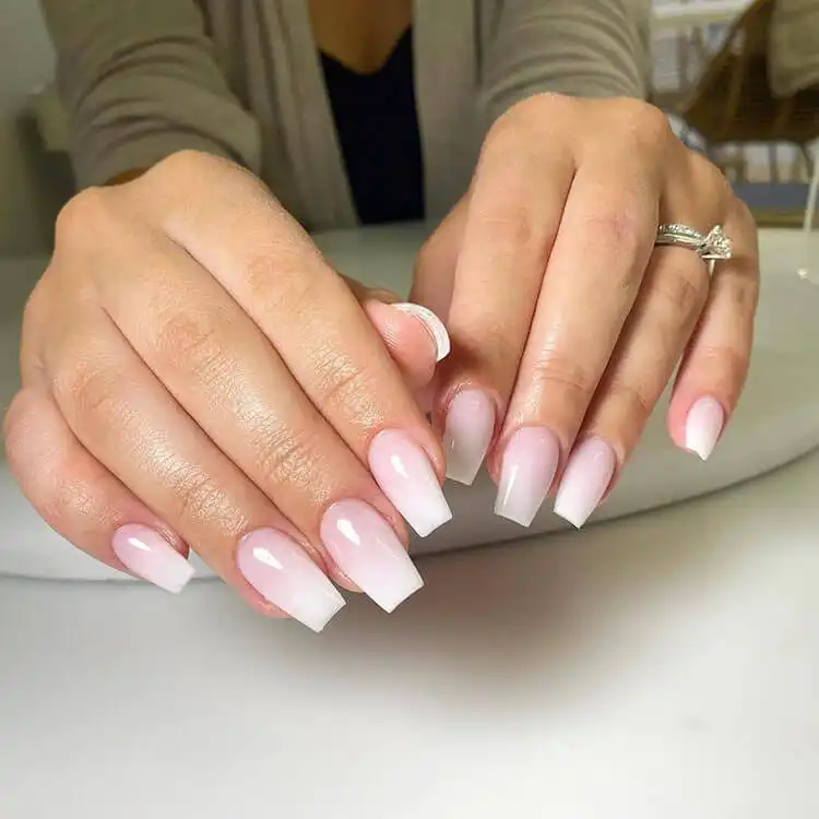 Subtle white ombre nails with a gentle fade from nude pink to white, ideal for an elegant and minimalist manicure.