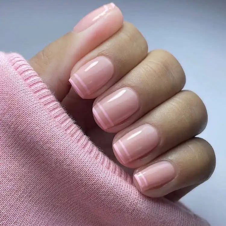 Simple striped nail design in pink and white, an easy DIY option that looks great on various nail lengths.