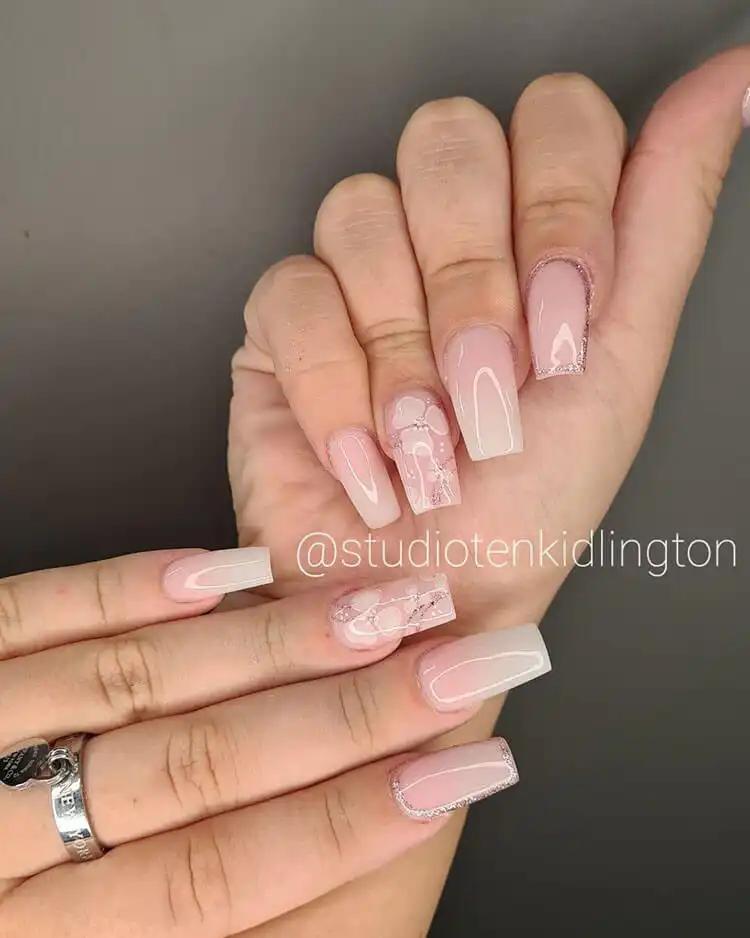 Subtle ombre nails enhanced with delicate embellishments like flowers, glitter, or rhinestones for an elegant finish.