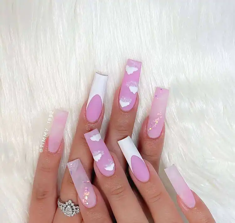 Dreamy pink cloud nails, featuring artistic fluffy clouds against a soft pink sky, a whimsical and serene design.