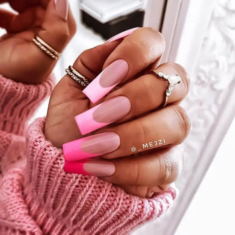 Stunning pink ombre nails transitioning through different shades of pink from dark to light, offering a feminine and vibrant look.