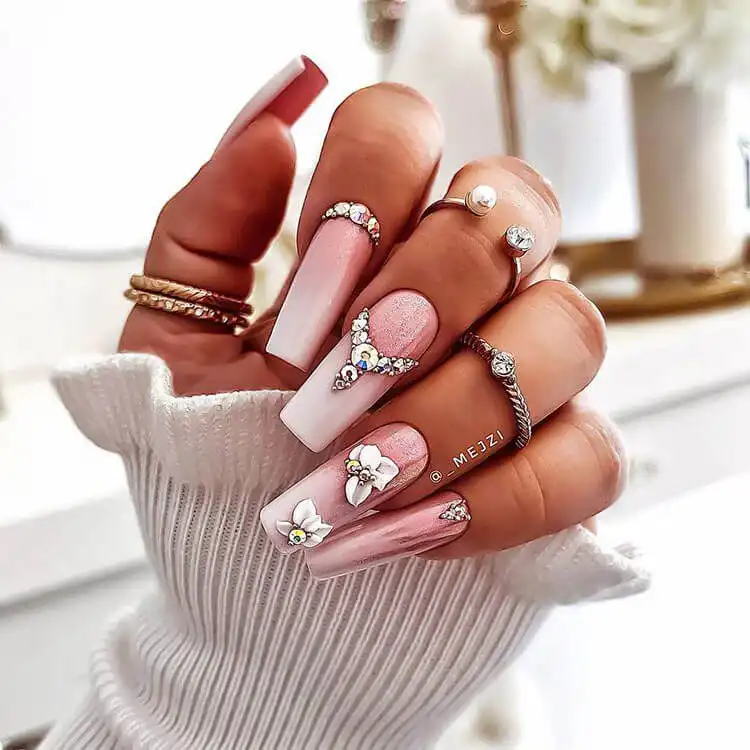 Beautiful pink nails embellished with sparkling rhinestones, adding a touch of glamour and sophistication.
