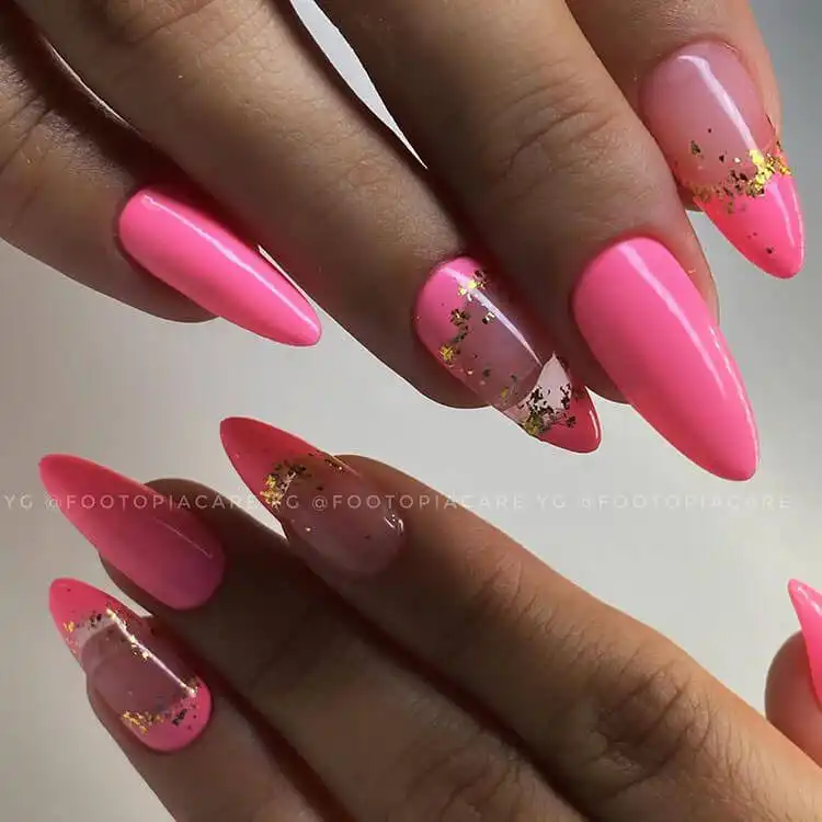 Elegant pink and gold nail design combining soft pink with shimmering gold accents for a luxurious appearance.