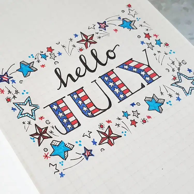 July Bullet Journal Cover Page Ideas 12 Stars and fireworks border around 'July' text on a bullet journal cover.