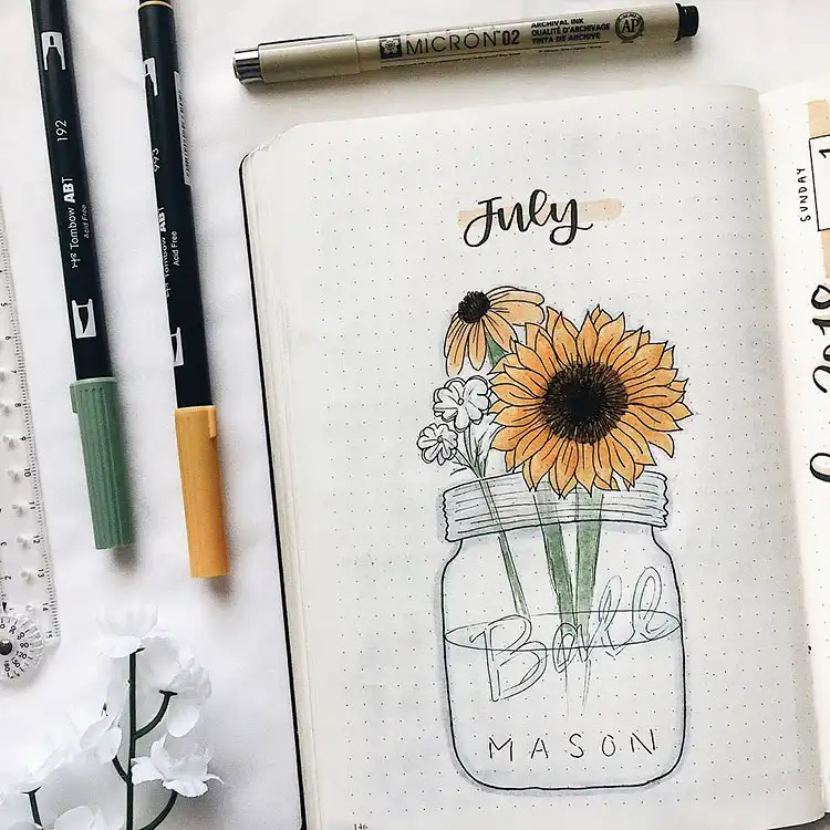 July Bullet Journal Cover Page Ideas 20 Sunflowers arranged in a mason jar for a rustic July bullet journal cover.