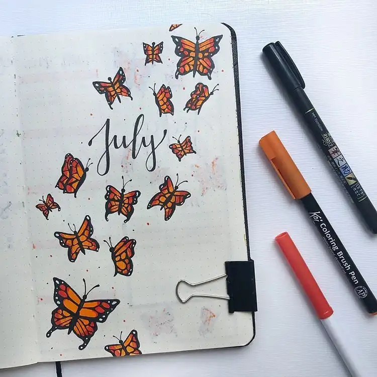 July Bullet Journal Cover Page Ideas 5 Orange butterflies flying on a July bullet journal cover, with summer colors.