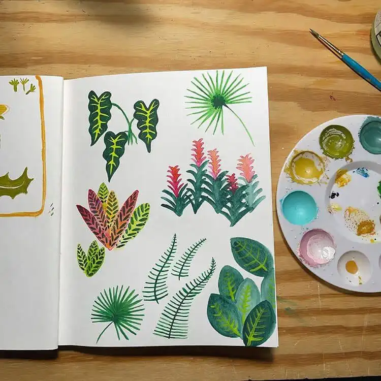 Variety of gouache paint tubes in different colors, essential for any artist looking to learn how to paint a gouache flower.