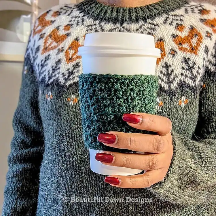 A charming morning brew crochet cup cozy on a coffee mug, featuring a simple, quick-to-make design.