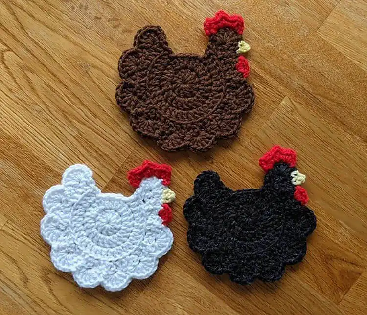 A set of whimsical crochet chicken coasters, perfect for farmhouse decor, adding a quirky touch to beverages.