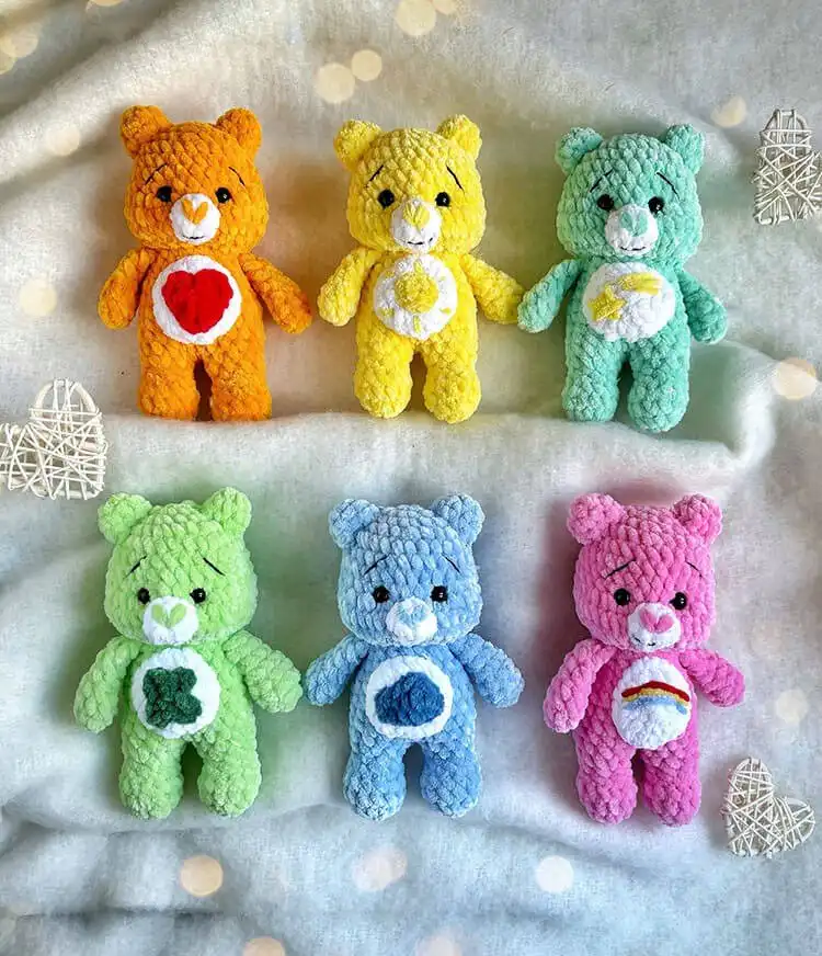 A delightful display of colorful rainbow bears, made with a low sew crochet care bears pattern, highlighting their cheerful expressions and individual charm.