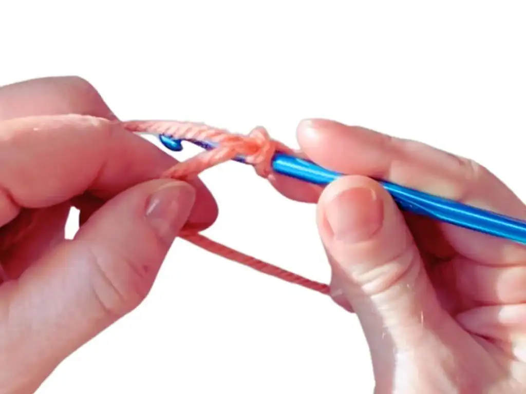 Step 6: Slipping yarn off fingers and taking loose end off the loop.