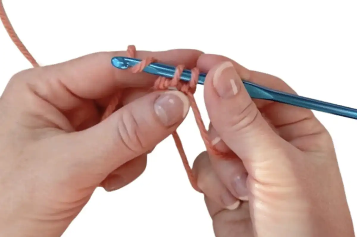 Step 7: Wrapping working yarn around hand, adjusting loop size for stitches.